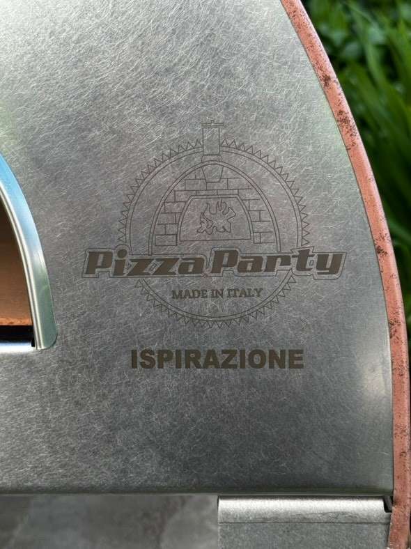 Logo detail for Pizza Party Made in Italy, featuring the word Inspiration on the antique copper gas oven
