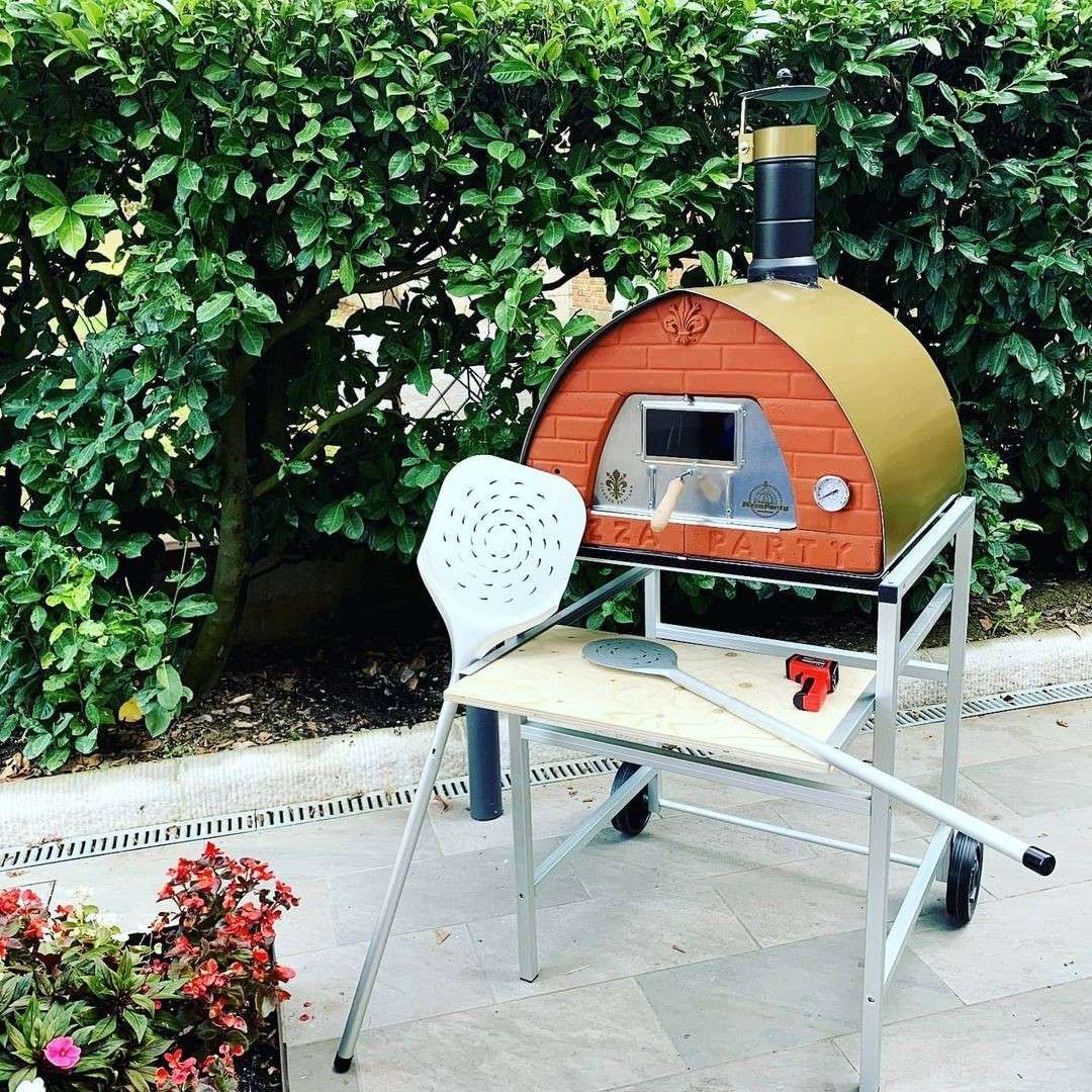 Pizza Party 70x70 wood-fired oven with wheeled aluminum stand and garden shovel